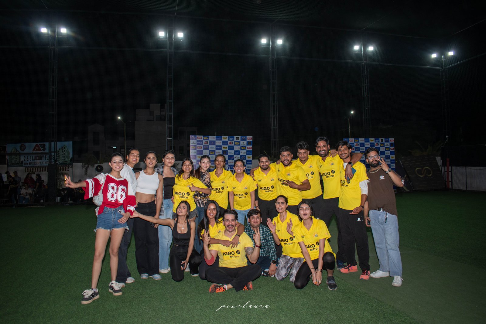 RaRa Events team posing together in front of the sponsor wall after a signature event