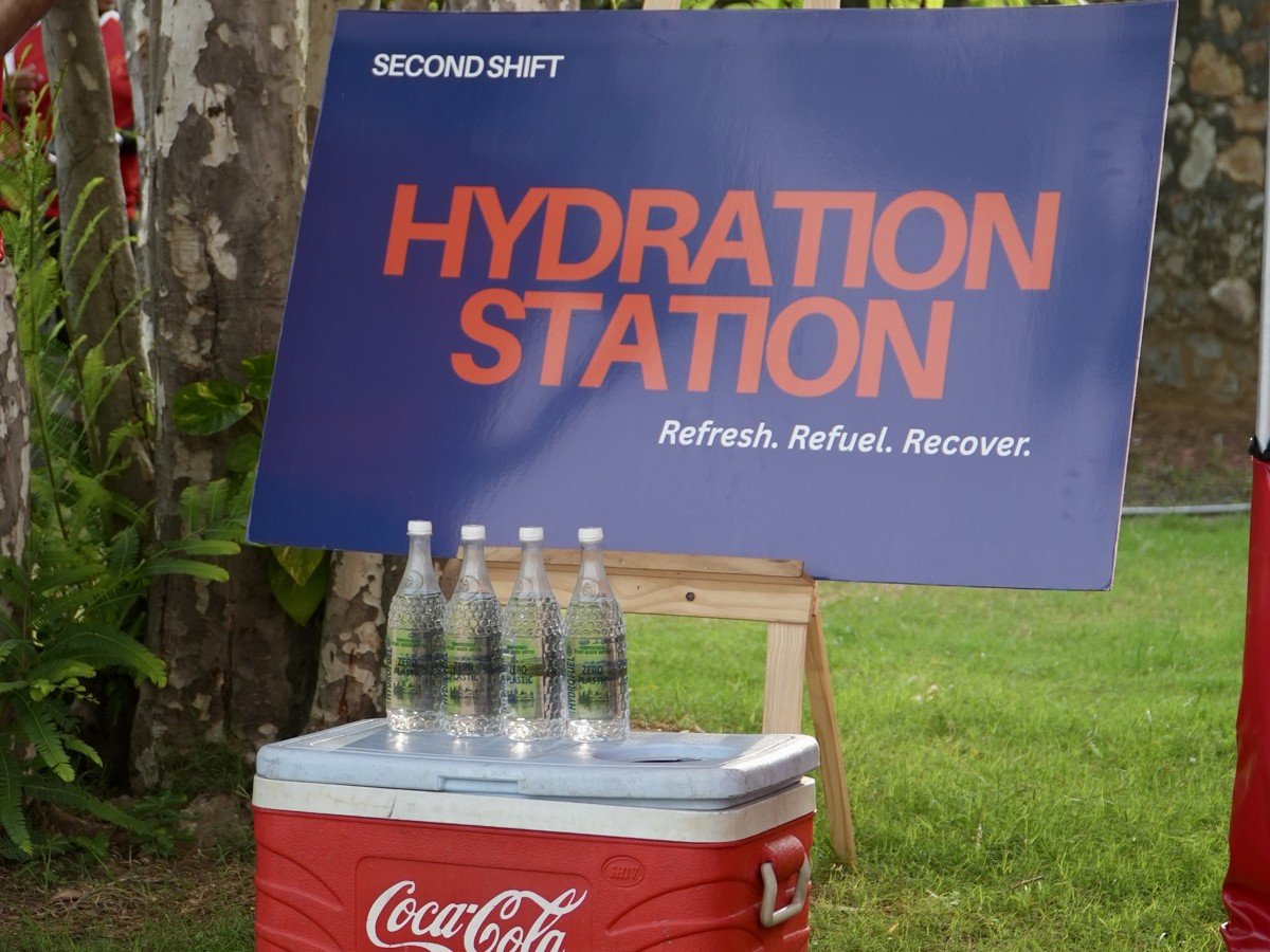 Branded RaRa Events Hydration Station with a Coca-Cola cooler at a corporate sports event